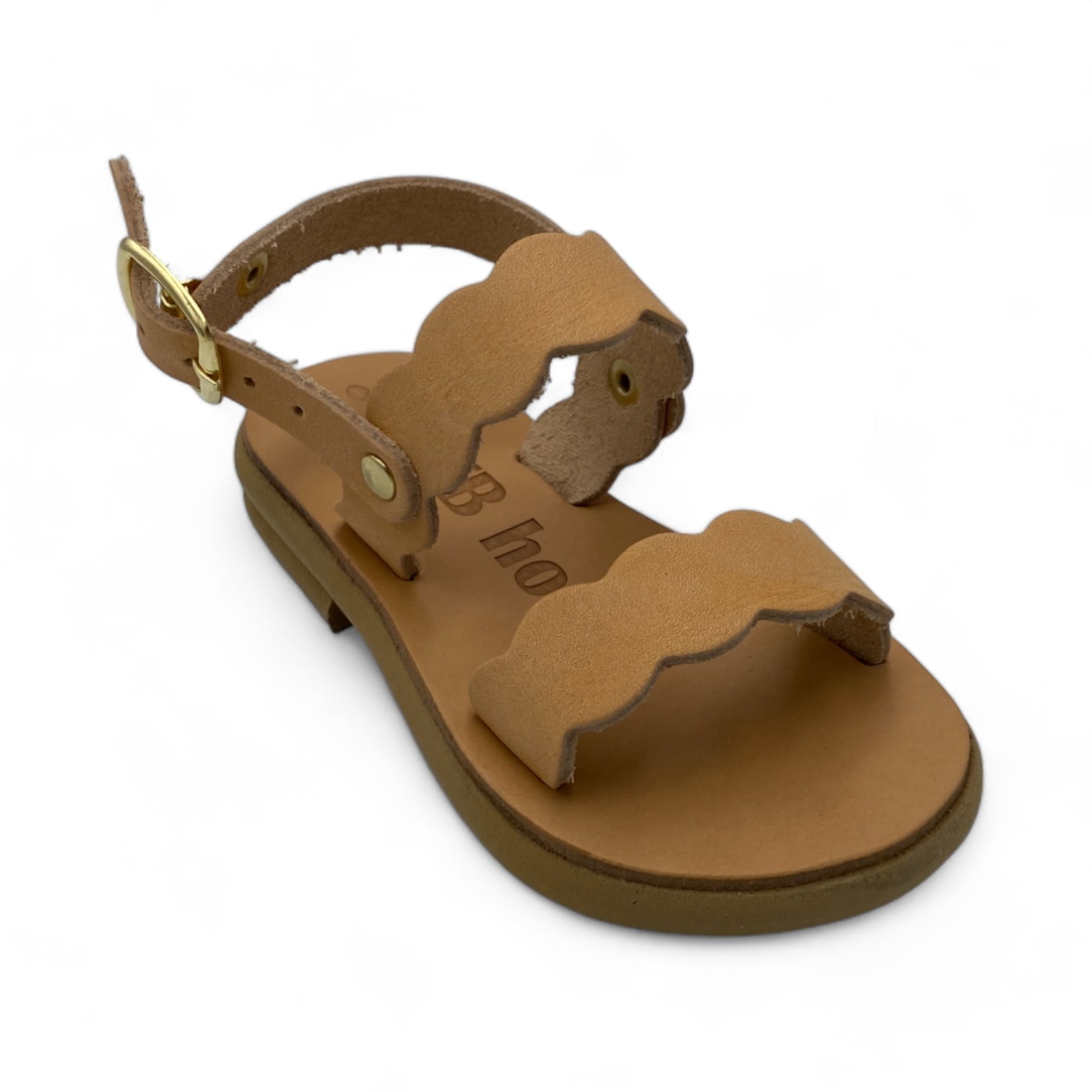 Brown leather sandal with scalloped straps and ankle buckle, close-up view